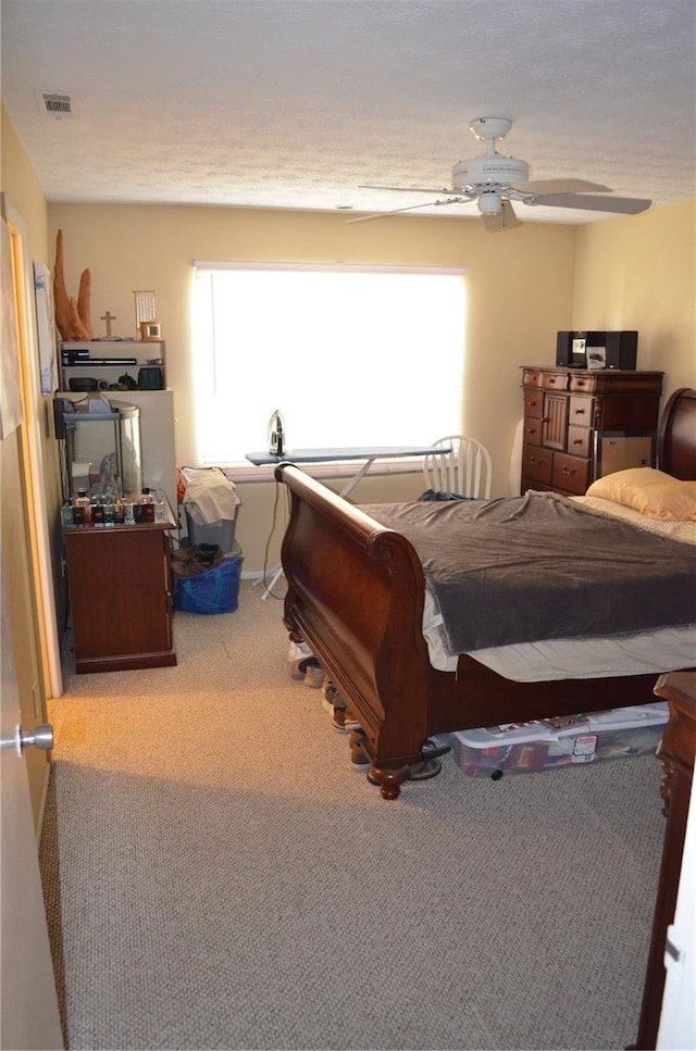 bedroom with light carpet and ceiling fan