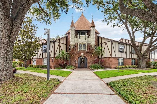 5413 Hansel Ave Unit K10, Orlando, FL 32809 - view of front facade with brick siding, a front yard, and stucco siding