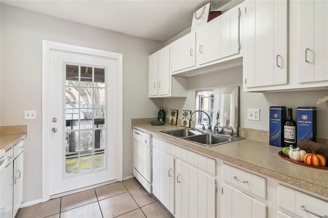 5413 Hansel Ave Unit K10, Orlando, FL 32809 - kitchen featuring white dishwasher, light countertops, white cabinets, and light tile patterned flooring