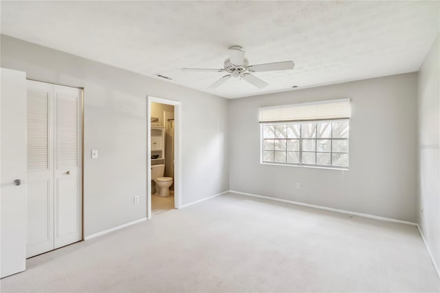 5413 Hansel Ave Unit K10, Orlando, FL 32809 - unfurnished bedroom featuring carpet flooring, a closet, a ceiling fan, and ensuite bathroom