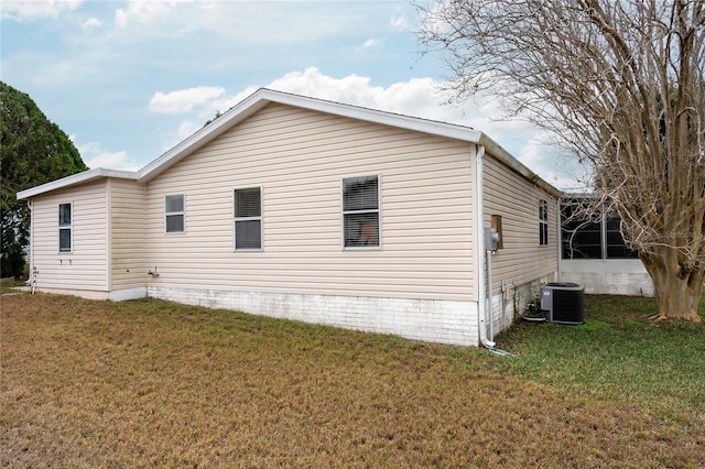 exterior space featuring a yard and central AC unit