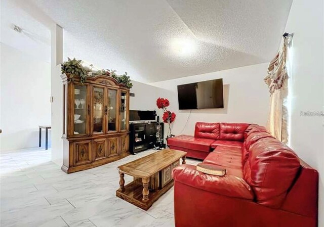 5633 Piney Ridge Dr, Orlando, FL 32808 - living room featuring a textured ceiling