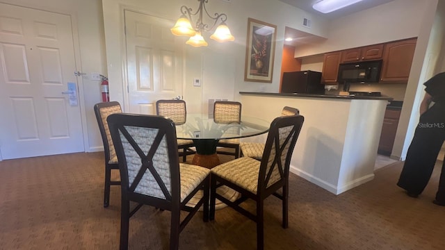 8112 Poinciana Blvd, Orlando, FL 32821 - dining area with dark carpet, visible vents, a notable chandelier, and baseboards