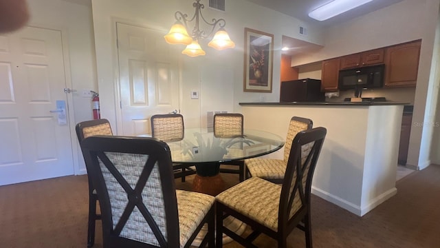8112 Poinciana Blvd, Orlando, FL 32821 - dining space with an inviting chandelier, visible vents, dark carpet, and baseboards