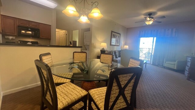 8112 Poinciana Blvd, Orlando, FL 32821 - dining space featuring carpet flooring, baseboards, and ceiling fan with notable chandelier