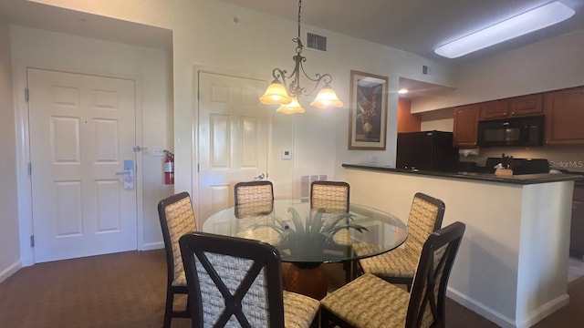 8112 Poinciana Blvd, Orlando, FL 32821 - dining area featuring a chandelier, visible vents, dark colored carpet, and baseboards