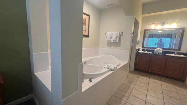 8112 Poinciana Blvd, Orlando, FL 32821 - full bathroom featuring a sink, a bath, double vanity, visible vents, and tile patterned flooring