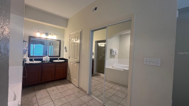 8112 Poinciana Blvd, Orlando, FL 32821 - full bathroom with visible vents, a stall shower, a bath, tile patterned floors, and vanity