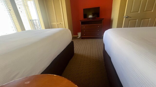 8112 Poinciana Blvd, Orlando, FL 32821 - carpeted bedroom featuring a closet and baseboards
