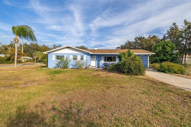 ranch-style home featuring a front yard