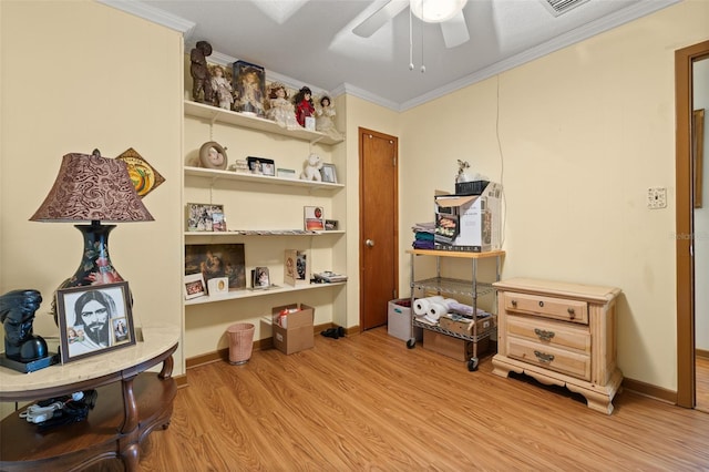 miscellaneous room featuring ornamental molding, ceiling fan, and light wood-type flooring