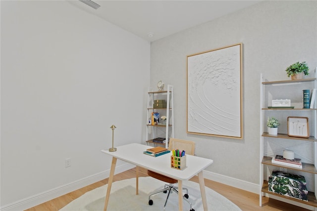 office area with wood finished floors and baseboards