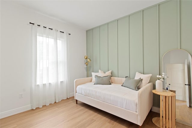bedroom with light wood-type flooring and baseboards