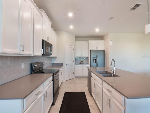 kitchen featuring pendant lighting, sink, black electric range, and stainless steel fridge with ice dispenser