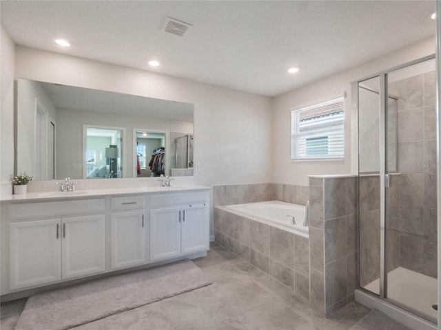 bathroom with tile patterned floors, vanity, and plus walk in shower