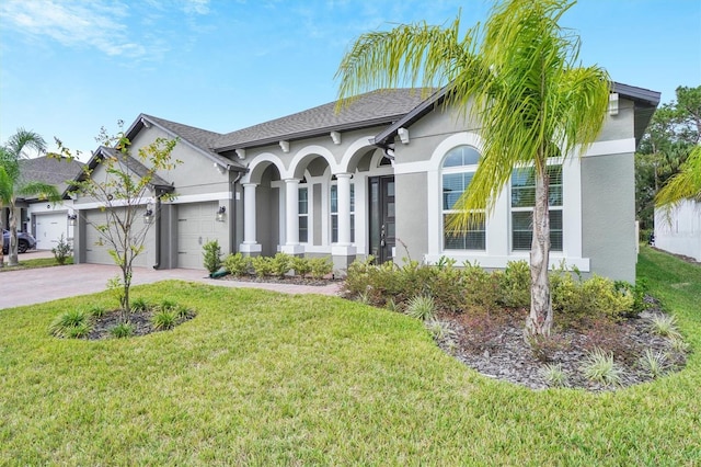 view of front of property with a garage and a front lawn