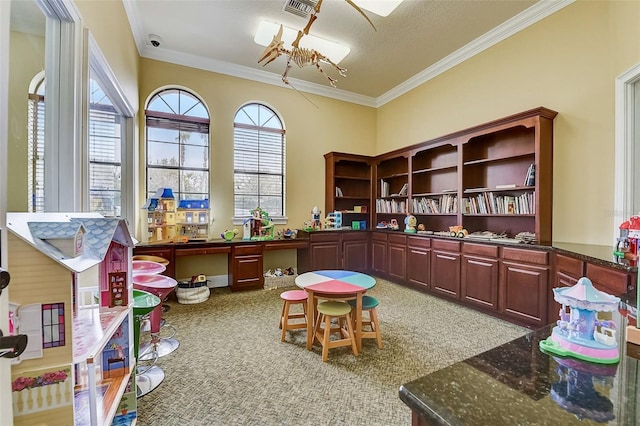 game room featuring ornamental molding, carpet floors, a textured ceiling, and a chandelier