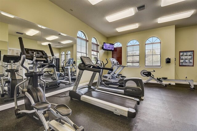 workout area featuring a textured ceiling