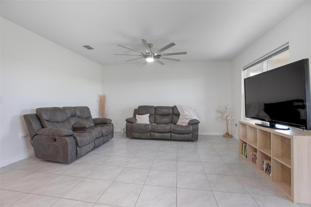 living area featuring a ceiling fan, visible vents, baseboards, and light tile patterned flooring