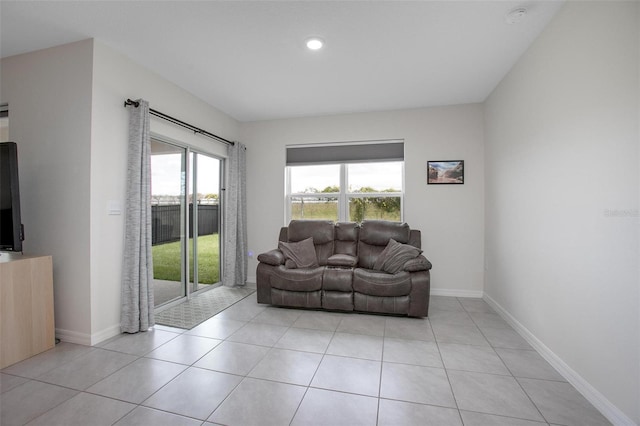 living room with light tile patterned floors and baseboards