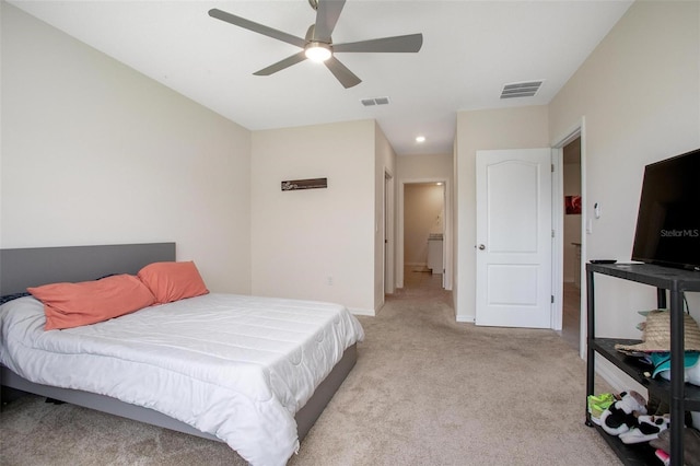 bedroom with light carpet, ceiling fan, visible vents, and baseboards