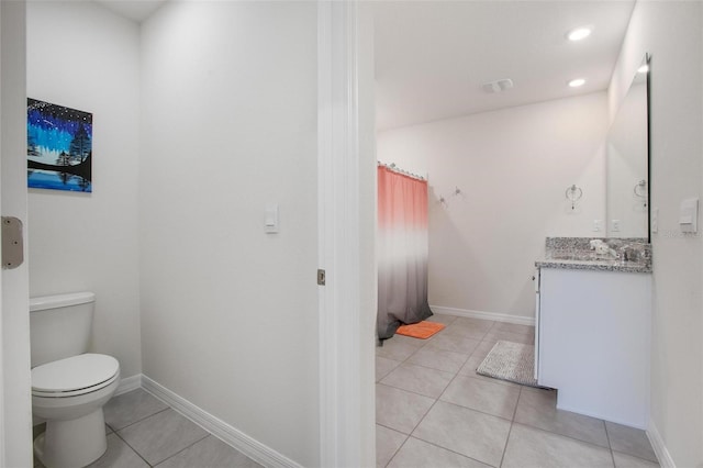 bathroom featuring baseboards, toilet, tile patterned floors, vanity, and recessed lighting