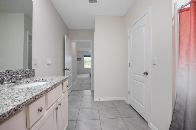 full bath featuring tile patterned flooring, visible vents, baseboards, and vanity