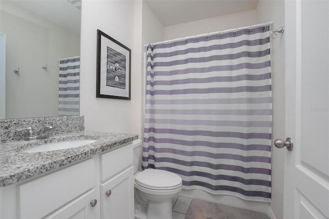 bathroom with tile patterned flooring, vanity, and toilet