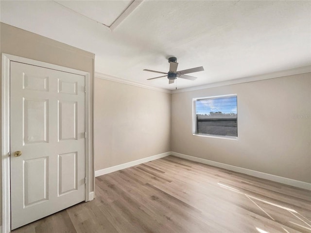 unfurnished room with ornamental molding, light hardwood / wood-style floors, and ceiling fan