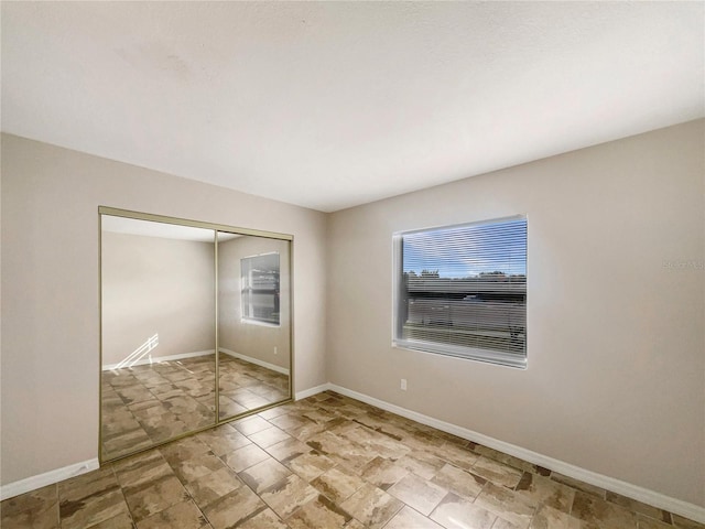 unfurnished bedroom with a closet