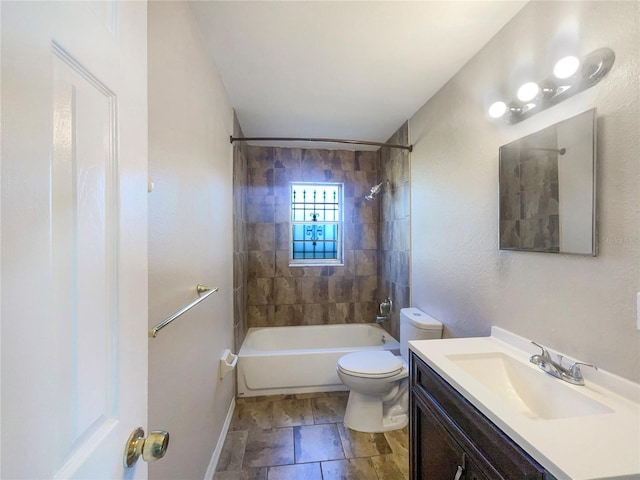 full bathroom featuring tiled shower / bath combo, vanity, and toilet