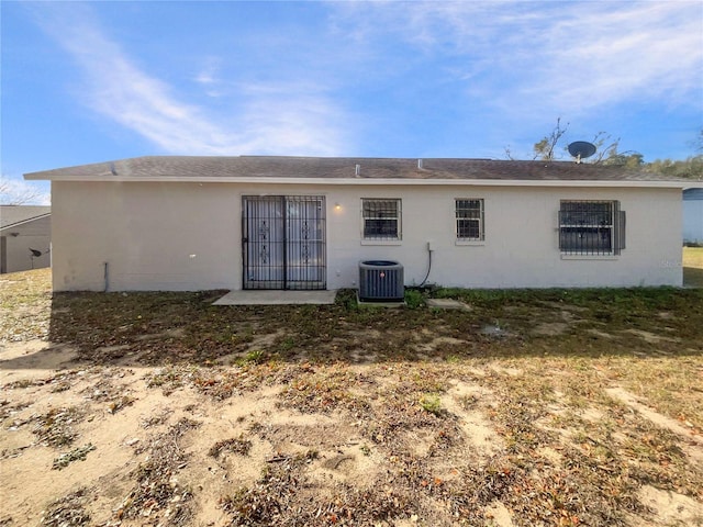 rear view of property with central AC unit