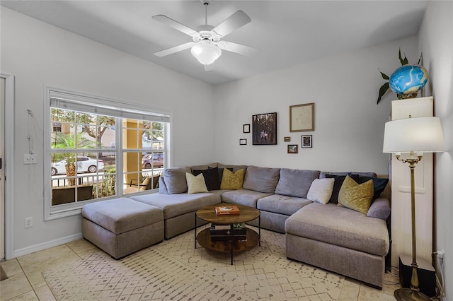 living room featuring light tile patterned floors and ceiling fan