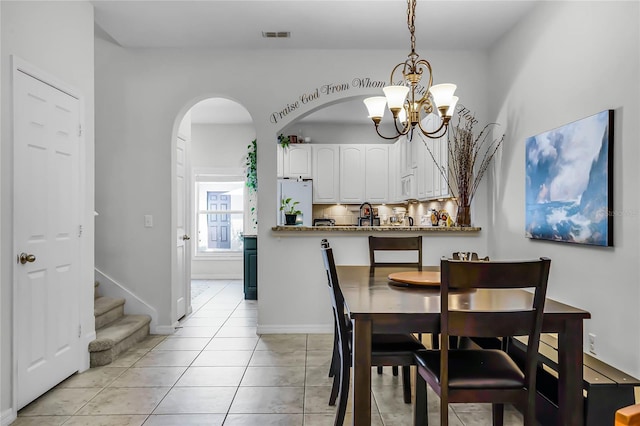 dining room featuring an inviting chandelier and light tile patterned floors