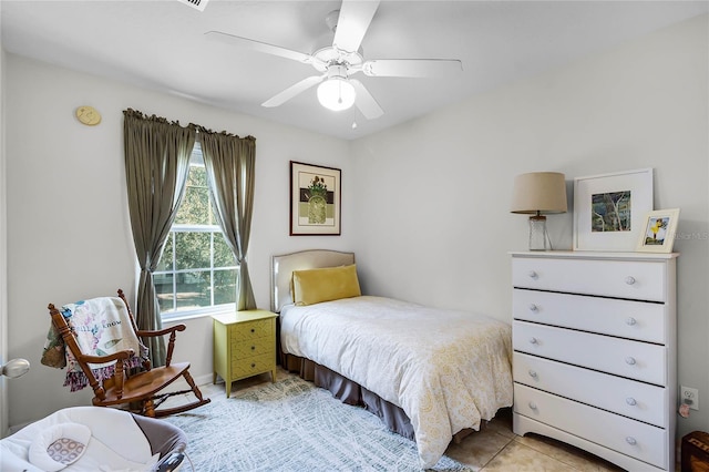 tiled bedroom with ceiling fan