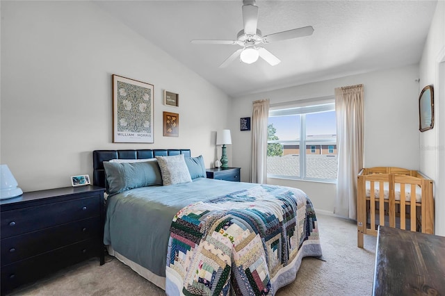 carpeted bedroom featuring ceiling fan and vaulted ceiling