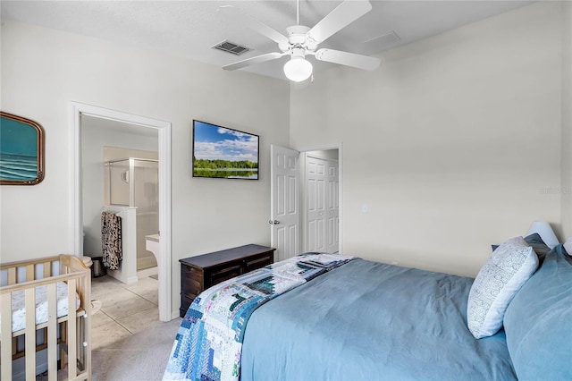 bedroom featuring light carpet, ensuite bath, lofted ceiling, and ceiling fan