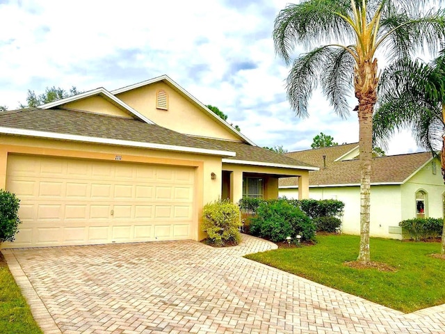 ranch-style house with a garage and a front yard