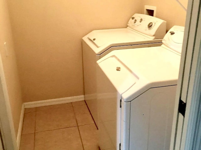 laundry area featuring tile patterned flooring and washer and clothes dryer