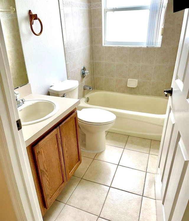 full bathroom with tile patterned flooring, vanity, toilet, and tiled shower / bath