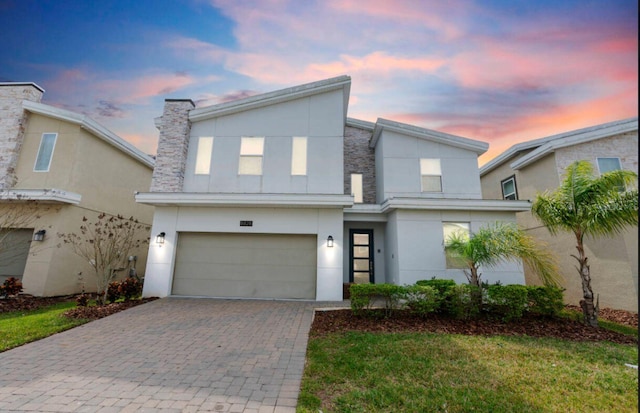 modern home with a garage and a yard