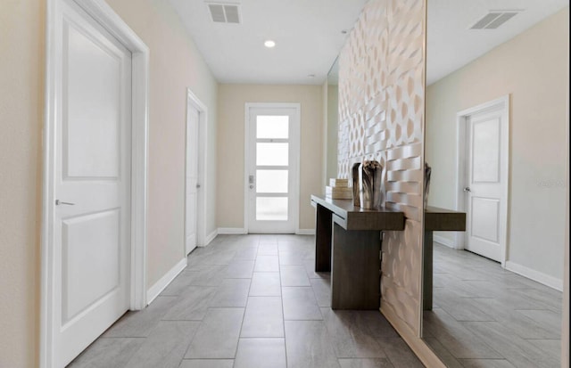 doorway to outside featuring light tile patterned floors