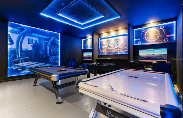 game room with billiards, concrete flooring, and a raised ceiling