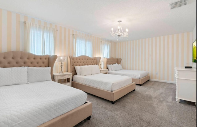 carpeted bedroom featuring an inviting chandelier