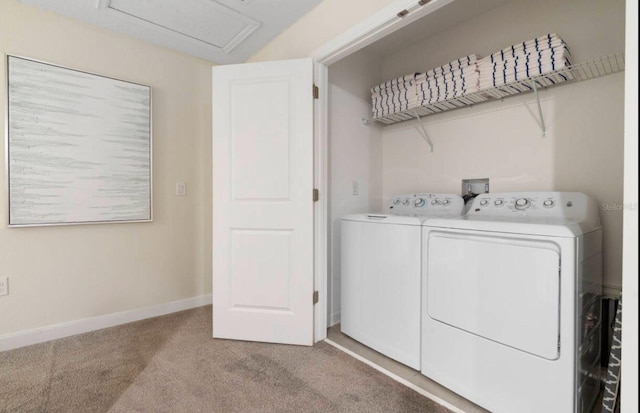 clothes washing area with separate washer and dryer and light carpet