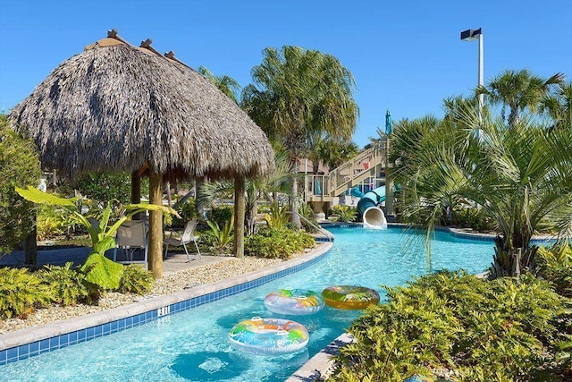 view of swimming pool featuring a gazebo and a water slide