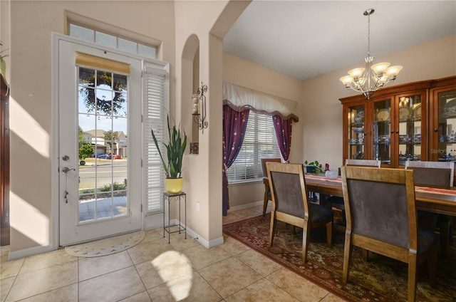 tiled dining space featuring a notable chandelier