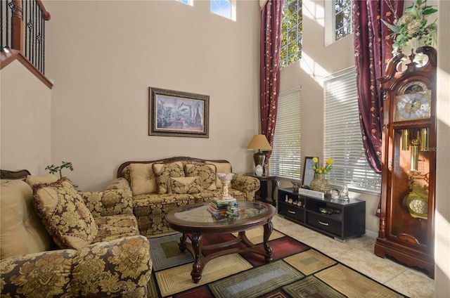 tiled living room with a high ceiling