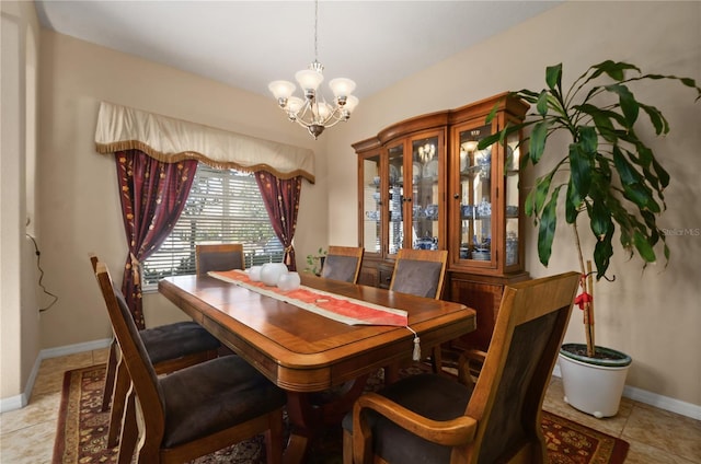 tiled dining space featuring a chandelier