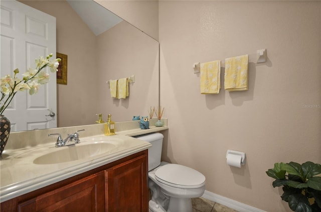 bathroom with tile patterned floors, vanity, toilet, and vaulted ceiling